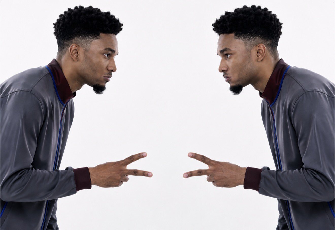Two of him pointing finger guns at each other